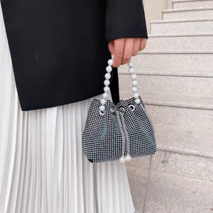 Rhinestone bucket bag with pearl handle and chain strap for women fashion details.