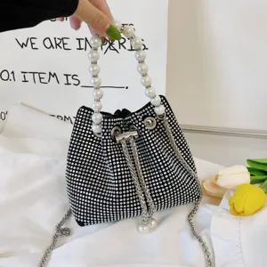 Stunning black rhinestone bucket bag with elegant faux pearl top handle and chic chain strap.