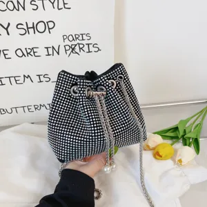Rhinestone bucket bag with chain strap and pearls, detailed view of sparkling black handbag.