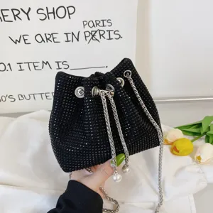 Black rhinestone bucket bag detail, sparkling crystal crossbody bag with chic chain and pearl straps.