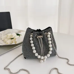 Black rhinestone bucket bag with pearl handle and metal chain for stylish daily wear.