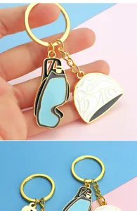 Details of swimming club themed metal keychain featuring mini goggles and swim cap charms.