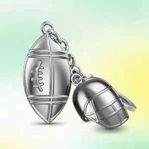 Metal American football helmet keychain charm, sports souvenir gift pendant for fans.