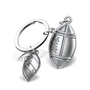 Silver metal American football keychain with helmet pendant, stylish keyring for sports fans.
