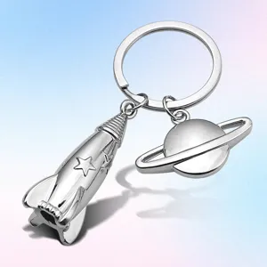 Silver metal rocket and saturn planet keychain pendant for space lovers and unique gifts.