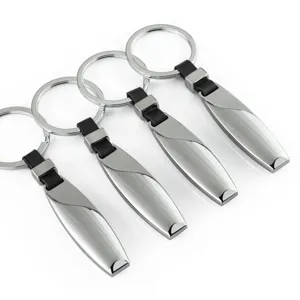 Metal car keychain with leather strap, sleek teardrop design, durable ring for keys and accessories.