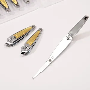 Stainless steel slant nail clipper detail view showcasing the gold traditional pattern.