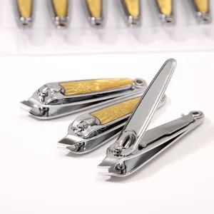 Stainless steel slanted nail clipper detail showing gold decorative handle design.