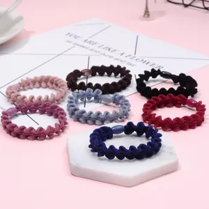 Detailed close-up of colorful wavy braided hair ties showing textured elastic and center beads.