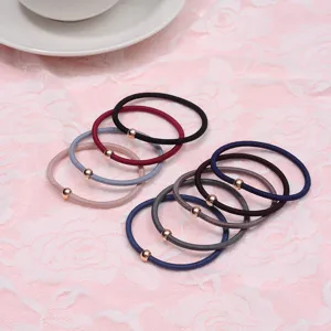 Detail view of simple elastic hair ties with small metal beads in multi colors for daily use.