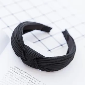 Detailed view of a black pleated knot headband, vintage fabric hair hoop for daily wear.