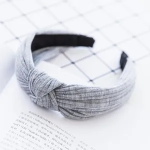 Grey fabric headband with twisted knot design, soft and comfortable for daily wear and washing.