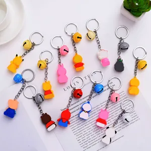 Detailed view of cute cartoon character silicone keychains with metal rings and colorful bells.