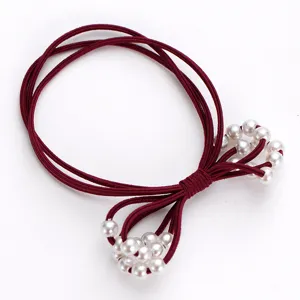 Elegant elastic hair tie with white pearls, durable rubber band for women daily use.