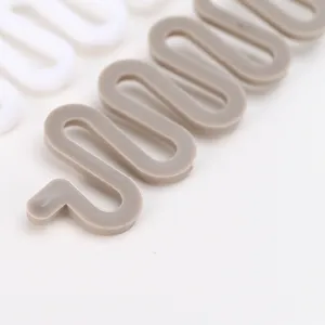 Close-up detail of plastic wave hair braiding tool, flexible styling accessory for women.
