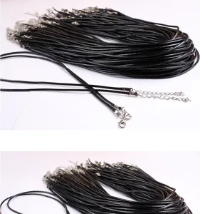 Black waxed cord necklace detail shot featuring durable metal lobster clasp and extension chain.