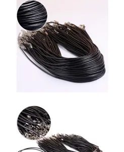 Detailed close-up view of black waxed cord necklace with silver metal clasps and chain.