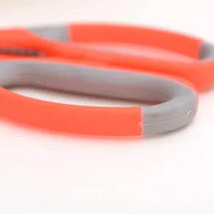 Close-up detail of ergonomic kitchen scissors dual-color non-slip handle grip in red and grey.