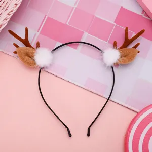 Christmas reindeer antler headband with plush ears and fluffy white pom-poms for festive party.