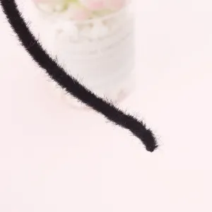 Black fuzzy headband detail close-up, soft plush hair hoop accessory for cute daily wear and cosplay.
