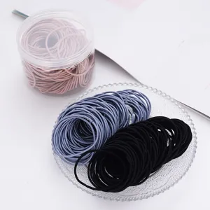 Close-up detail shot of elastic hair ties in various colors, neatly arranged for daily use.