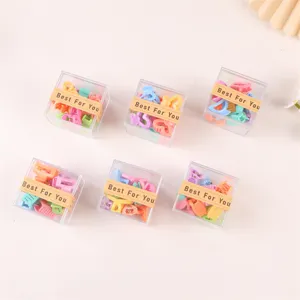 Colorful mini hair claw clips for kids, cute assorted hair accessories in clear boxes.
