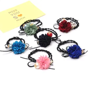 Colorful fabric flower hair ties with pearls and metal leaf charms for women and girls.