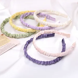 Detailed view of colorful satin ruffled headbands, soft fabric texture for daily sweet hair styling.