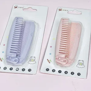 Portable folding hair comb in pink and purple colors with cute cartoon blister package design.