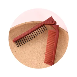 Portable folding hair comb with wood grain finish, compact double-sided travel hairbrush.