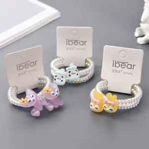 Detailed view of cute telephone wire hair ties with cartoon pendants and brand cards.