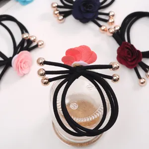 Fabric camellia flower hair ties with metal beads, elastic black rubber bands, detail view.