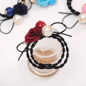 Elegant floral hair tie with faux pearl and bow design for daily charming hairstyles.