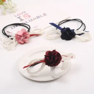 Elegant pearl flower hair tie with fabric camellia and ribbon, stylish elastic hair band.