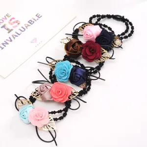 Fabric rose hair ties with golden leaves, elegant black elastic bands for daily wear.