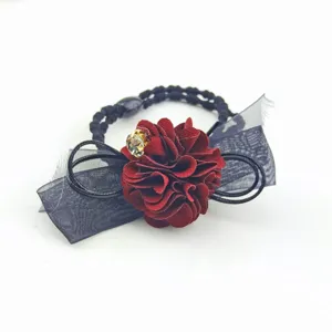 Close-up of elegant bow and camellia flower hair ring detail, rhinestone decoration.