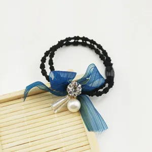 Blue bowknot hair tie with rhinestone, pearl, and crystal pendant on black double band.