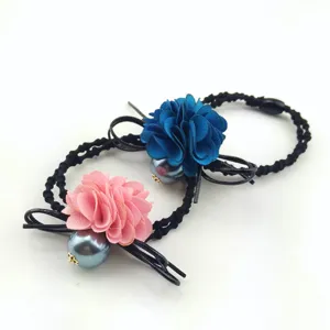 Detail shot of elegant fabric flower pearl hair ties with black elastic bands for daily hair styling.