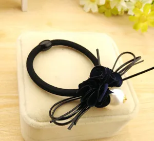 Black hair tie detail showing flower and pearl design for women daily hair styling.