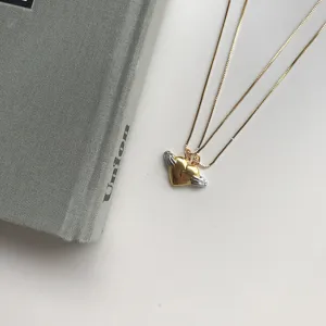 Detailaufnahme der Herzflügel Anhänger Halskette, silber und gold passender Partnerschmuck