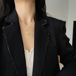 Detailed view of a vintage gold coin pendant necklace, elegant 925 silver jewelry for women.