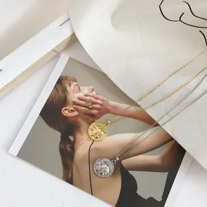 Vintage coin pendant necklace for women, stylish metallic portrait charm with delicate chain.