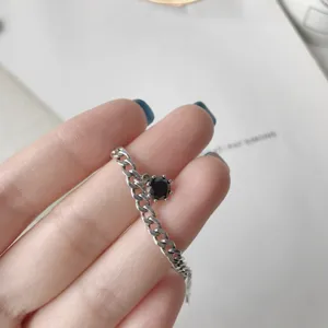 Silver chain ring with black zircon gemstone, vintage style retro aesthetic detail close-up