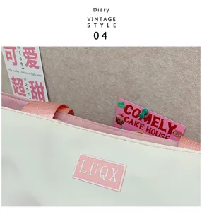 Cute college style cram school bag handbag detail showing off-white body pink handles and logo.