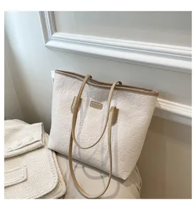 Detail view of the cute embossed large capacity commuting tote bag with stylish contrast straps.