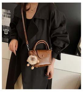 Vintage brown PU leather crossbody bag with plush charm, retro top handle handbag for women
