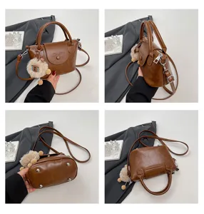 Retro brown PU leather handbag for women, versatile crossbody shoulder bag with fluffy charm.