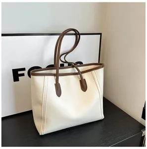 Detailed view of large capacity two-tone tote bag, PU leather handles, elegant minimalist style.