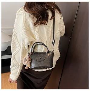 Chic retro women's handbag versatile casual crossbody shoulder bag with cute plush pendant.
