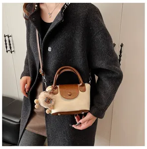 Chic vintage women handbag shoulder crossbody bag with contrast color and cute plush pendant.